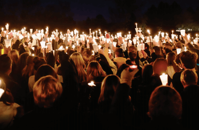 Photo of people holding candles for vigil