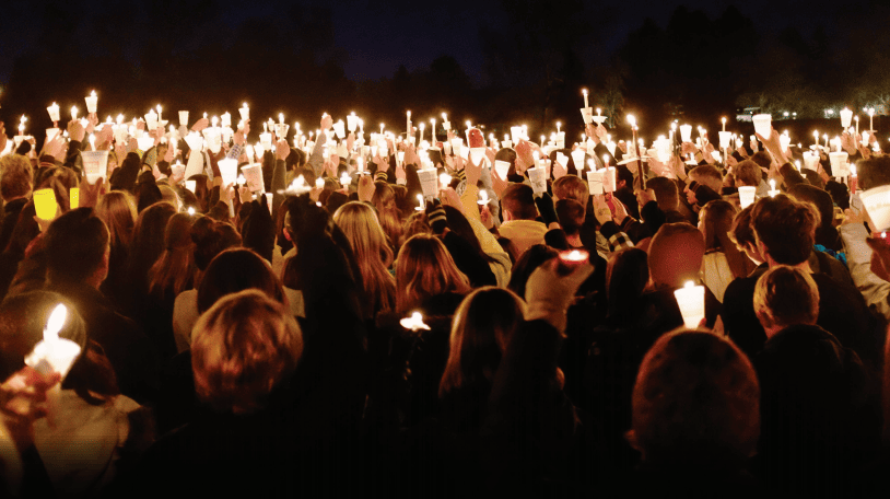 Photo of people holding candles for vigil